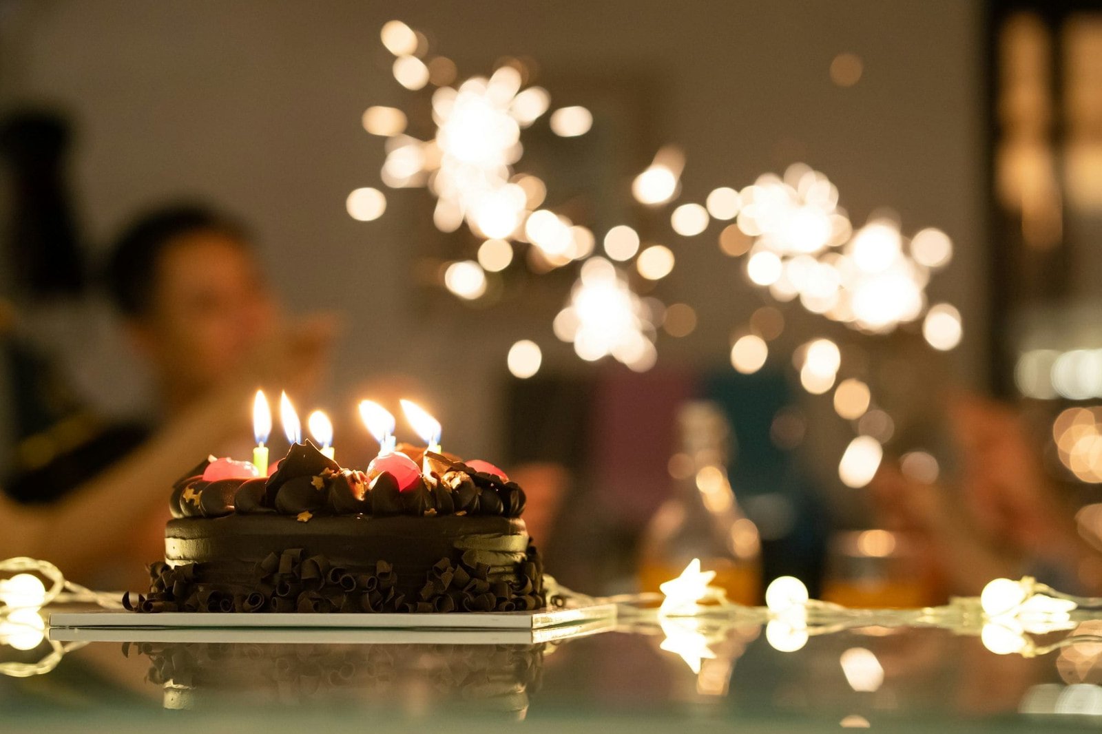 Asian family having fun celebrate happy birthday anniversary party at home