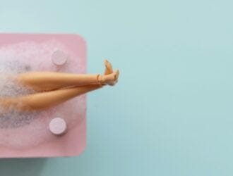 Doll legs in pink bath 🛁 on blue pastel background