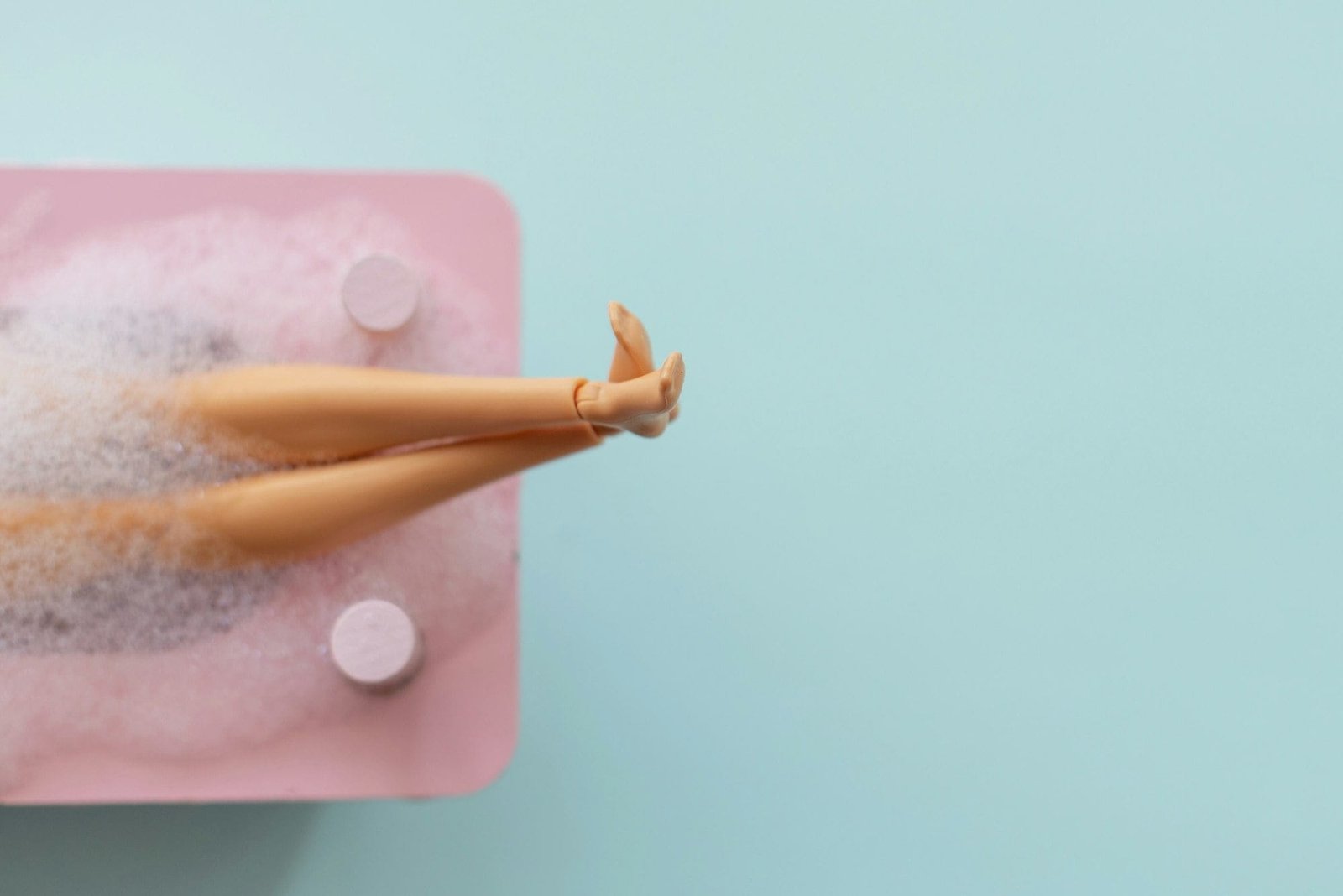Doll legs in pink bath 🛁 on blue pastel background