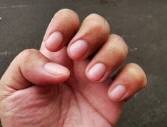 Man fingers with freshly cut nails.