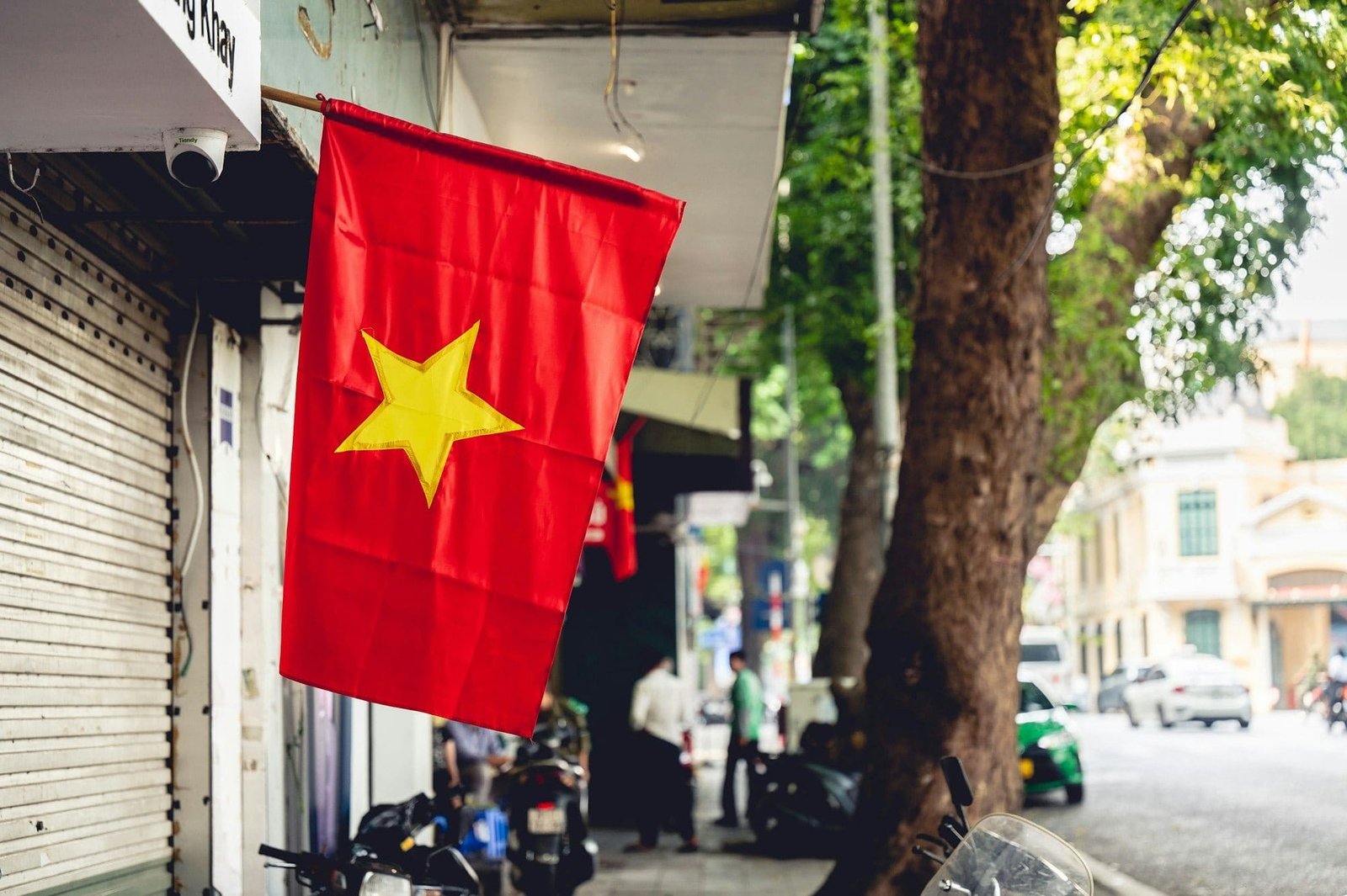 Scenic view of the Vietnamese flag hanging outside of a store