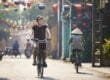 Tourist riding bicycle in old town in Vietnam