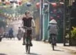 Tourist riding bicycle in old town in Vietnam