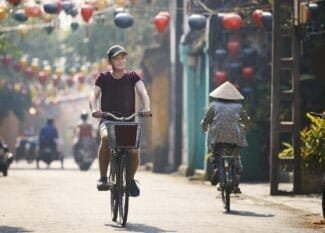 Tourist riding bicycle in old town in Vietnam