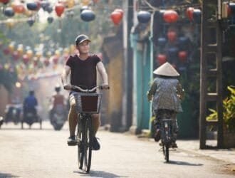 Tourist riding bicycle in old town in Vietnam