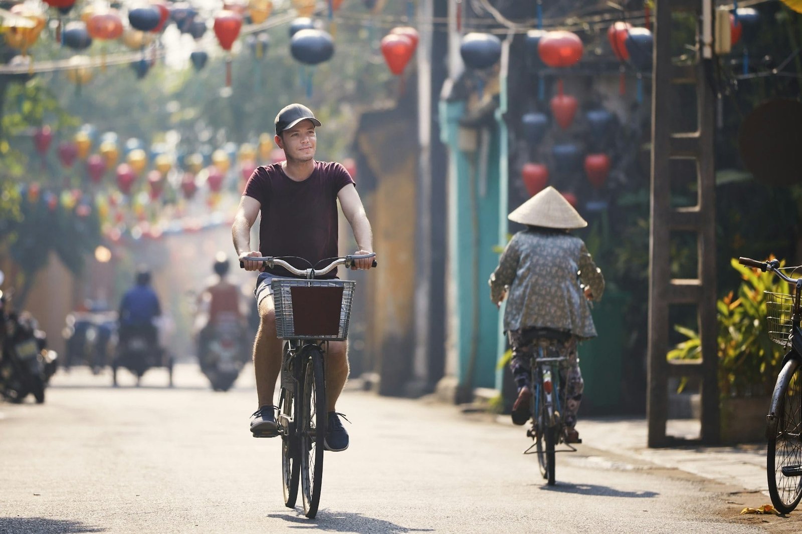 Tourist riding bicycle in old town in Vietnam